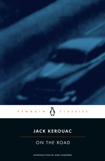 Book cover of On the Road by Jack Kerouac (Penguin Classics edition, introduction by Ann Charters), featuring a deep blue-black background with abstract blurred streaks of a car on a nighttime highway, white horizontal band with Penguin Classics logo, and dark bottom panel with orange author name and title—iconic Beat Generation novel of freedom, travel, and spiritual search