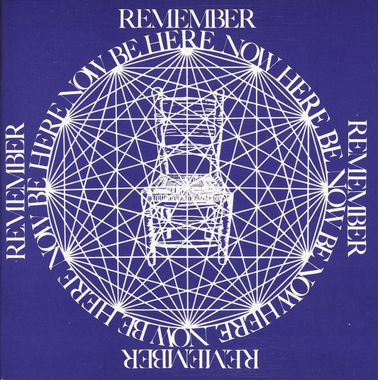 Book cover of Be Here Now (Remember, Be Here Now) by Ram Dass, featuring a deep purple background with white sacred geometry mandala—radial lines forming a circular grid around a simple wooden chair at center, encircled by repeating 'REMEMBER BE HERE NOW' text—iconic symbol of presence, mindfulness, and Zen awakening

